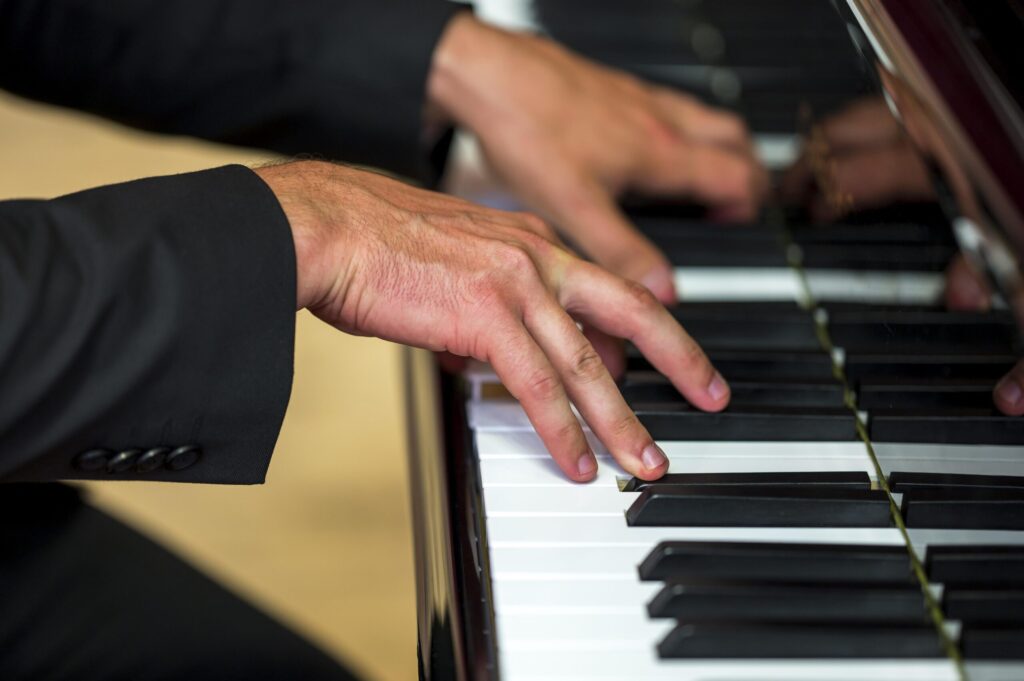 Closeup of man playing piano